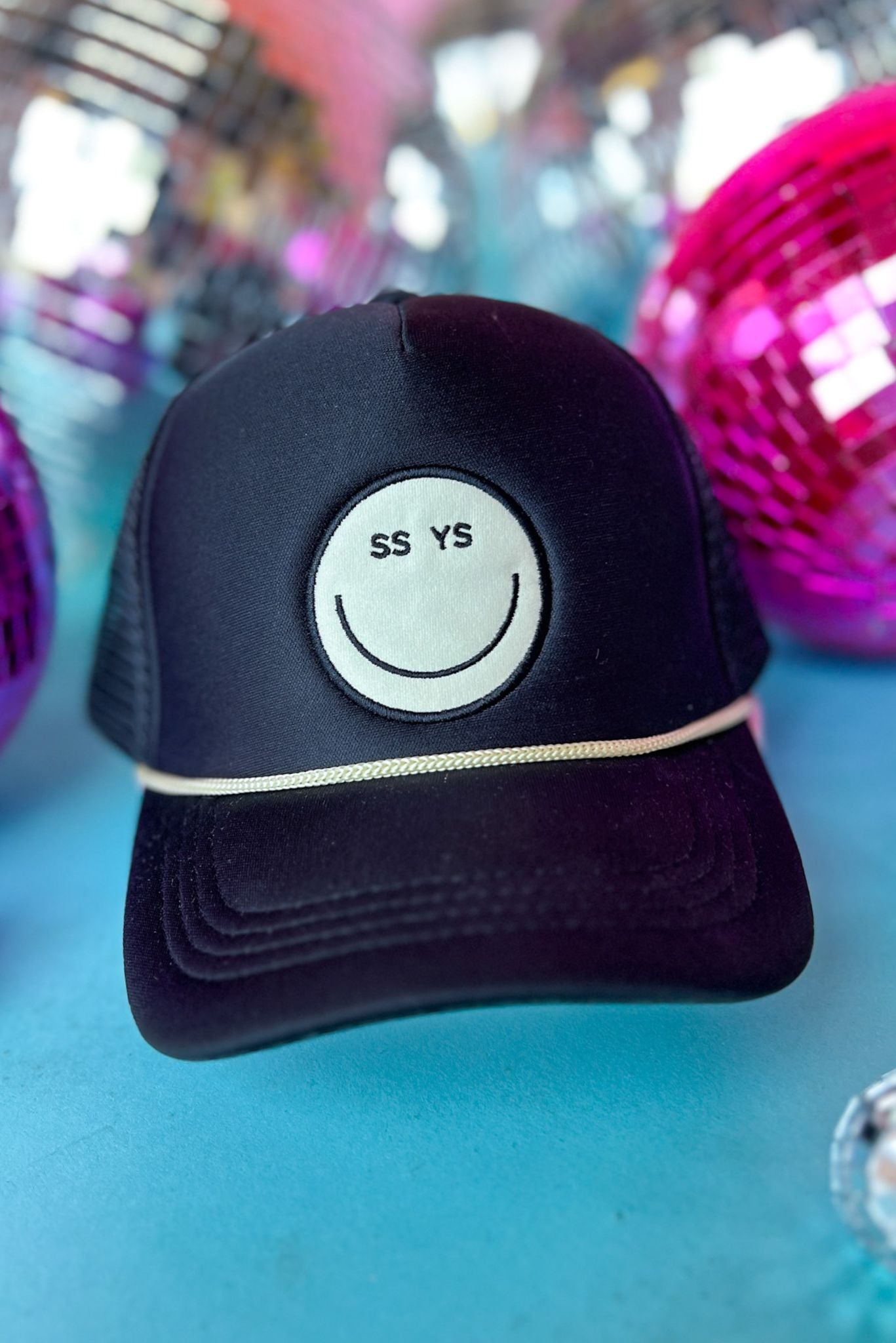 SSYS Black And Ivory Smiley Trucker Hat, accessory, hat, trucker hat, smiley face hat, black and ivory accessory, black and ivory hat, black and ivory trucker hat, black and ivory smiley face hat, must have accessory, must have hat, elevated accessory, elevated hat, elevated style, elevated styling, Shop Style Your Senses by Mallory Fitzsimmons, SSYS by Mallory Fitzsimmons